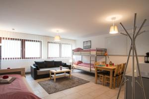 a living room with a couch and a bunk bed at Düsseldorf Comfort Apartment in Düsseldorf