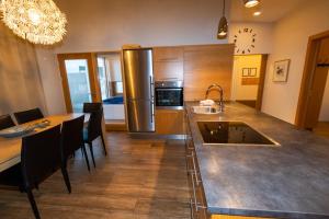 a kitchen with a large counter and a dining room at Hrimland Cottages in Akureyri