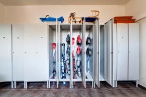 a room with a bunch of skis at Penzion Drak in Liptovský Mikuláš