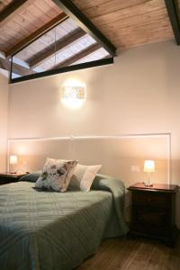 a bedroom with a bed and two tables with lamps at Agriturismo Ada Musso ss in Diano Borello +121 photos