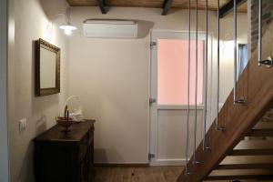 a hallway with a staircase and a door to a room at Agriturismo Ada Musso in Diano Borello