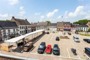 a group of cars parked in a parking lot at Hotel Het Wethuys in Watou