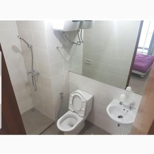 a bathroom with a toilet and a sink at 4 Bed Condo Sleeping by The Sea in Jakarta