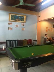 a man standing in front of a pool table at Dream Home Hostel in Vientiane