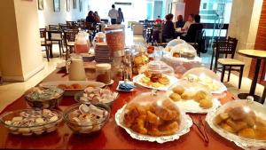 a table with many dishes of food on it at Plaza Hotel in La Rioja