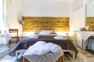 a bedroom with a bed with towels on it at Zabbara in Agrigento