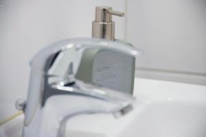 a close up of a bathroom sink with a faucet at Düsseldorf Comfort Apartment in Düsseldorf +133 photos