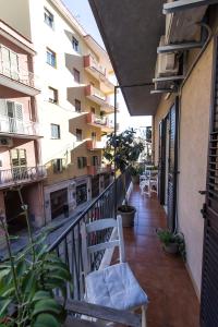 an apartment balcony with a chair and a balcony at Zabbara in Agrigento