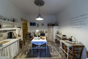 a kitchen with a table and a kitchen with a table and chairs at Zabbara in Agrigento