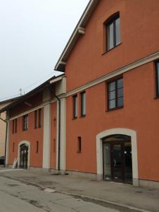 an orange brick building with an open door at City Westa Hotel in Rīga