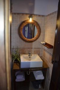 a bathroom with a sink and a mirror at Casa Rural Alada in Luelmo