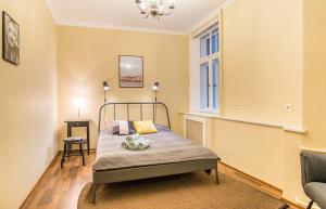 a bedroom with a bed and a window at Charming spacious 3 bedroom in Old Town in Riga