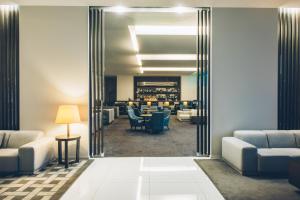 a lobby with a waiting room with couches and chairs at Iberostar Selection Lagos Algarve in Lagos