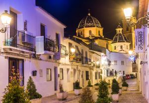a city street at night with a church in the background at Casa Carmen Altea with Terrace in Altea