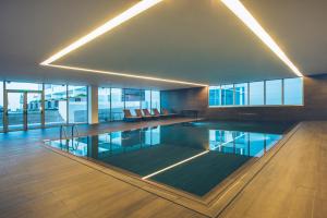 a swimming pool in a large building with a large at Iberostar Selection Lagos Algarve in Lagos