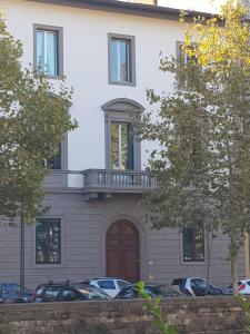 a building with cars parked in front of it at Loft Bianco in Florence