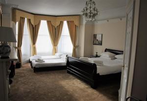 Ένα ή περισσότερα κρεβάτια σε δωμάτιο στο Castle House Hotel
