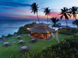 an aerial view of a resort on the beach at sunset at Taj Bentota Resort & Spa in Bentota