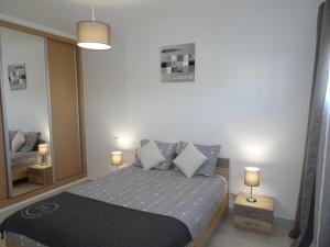 a bedroom with a bed and a large mirror at Copacabana by Check-in Portugal in Vilamoura