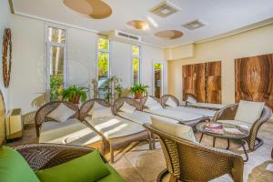 a room with wicker chairs and tables and windows at Residence Hotel Balaton in Siófok +53 photos