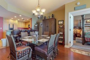 a dining room with a table and chairs at Portofino #1103 in Pensacola Beach