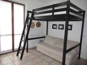 a bedroom with a bunk bed and a ladder at Monolocale Energy in Carona