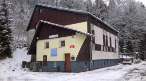 a building in the snow with a snow covered at Guest House Honzik in Horní Maršov