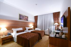 Emaar Al Mektan Hotel tesisinde bir odada yatak veya yataklar