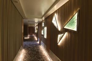 a hallway with lights on the walls of a building at The Athenian Callirhoe Exclusive Hotel in Athens