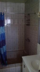 a bathroom with a shower and a sink at Don Santiago Guesthouse Downtown in San Ignacio