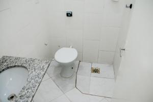 a bathroom with a toilet and a sink at Hotel Lumem Taguatinga Sul in Taguatinga