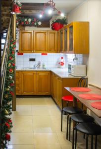 a kitchen with wooden cabinets and a christmas tree at hostel Koleso in Odesa