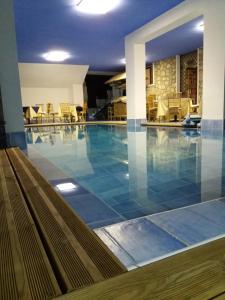 a pool in a hotel with a blue tile floor at Villa Betta in Cittadella del Capo