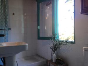 a bathroom with a sink and a mirror and a window at Casa ALMA in Hermigua