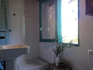 a bathroom with a sink and a mirror and a window at Casa ALMA in Hermigua +29 photos