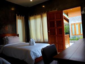 a bedroom with a bed and an open door at NawiengkaeRiverview Resort in Mukdahan +56 photos