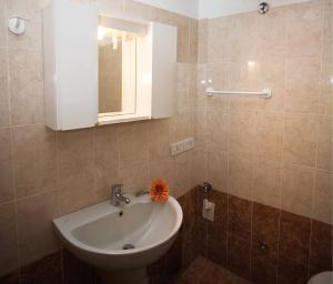 a bathroom with a sink with a flower on it at Linz in Bibione +17 photos
