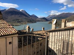 a large building with a view of a river and mountains at Ostello-Albergo dagli Elfi in Barrea