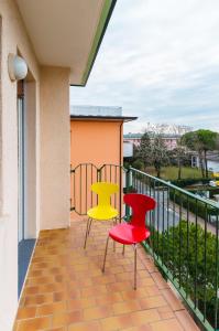 two chairs and a table on a balcony at Linz in Bibione