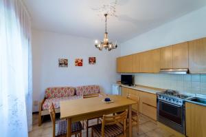 a kitchen with a table and a dining room at Manuela in Bibione