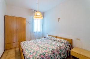 a bedroom with a bed and a dresser and a window at Manuela in Bibione