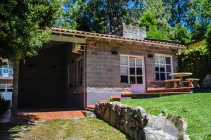 una pequeña casa de ladrillo con una pared de piedra en La Casa de Liber en Tandil