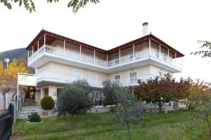 a large white building on top of a hill at Villa PANORAMA in Levidhion