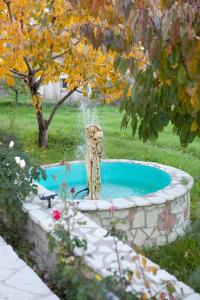 a fountain in the middle of a yard at Villa PANORAMA in Levidi