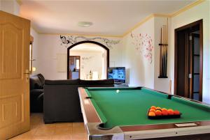 a living room with a pool table and a couch at Es Marroig Villa y Spa in Llucmajor