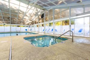 a swimming pool in a building with a swimming pool at Country Club Villas by Capital Vacations in Myrtle Beach