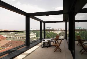 a view from the balcony of a building with a table and chairs at Sense Hotel Sofia, a Member of Design Hotels in Sofia