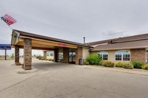 un edificio con una bandera delante de él en Fireside Inn and Suites en Devils Lake