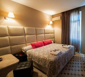 非斯的住宿－德拉派克斯酒店，酒店客房,设有一张带大型床头板的床