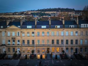 
a large building with a clock on the front of it at No 15 by GuestHouse, Bath in Bath
